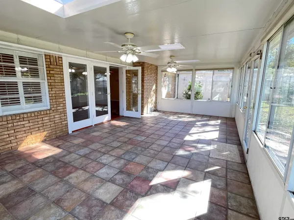 a view of a porch with a dining table and chairs