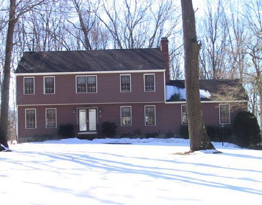 a front view of a house with a trees
