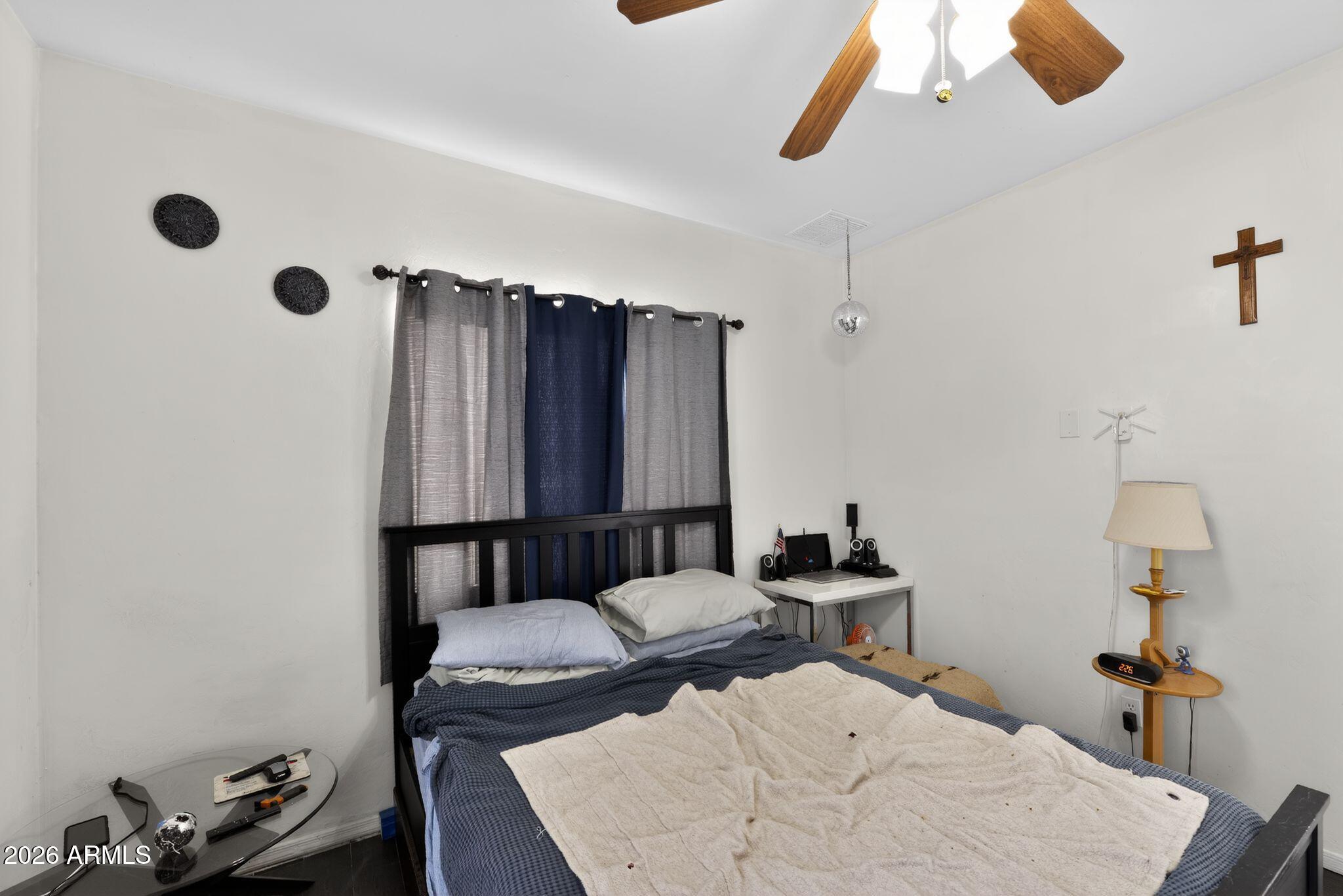 277 Círculo Silva Rio Rico, AZ 85648 - Photo 17 of 34 a bedroom with a bed and wooden floor