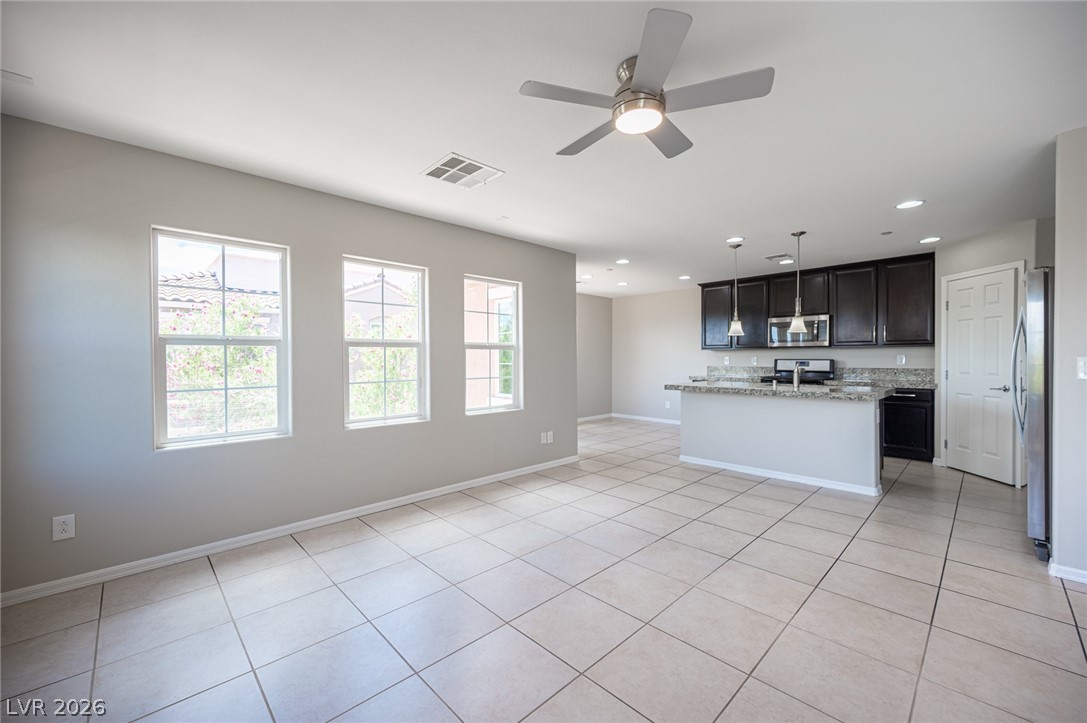 9916 Sable Point Street Las Vegas, NV 89178 - Photo 28 of 73 An open concept living area seamlessly flows into a well-appointed kitchen, ideal for entertaining.