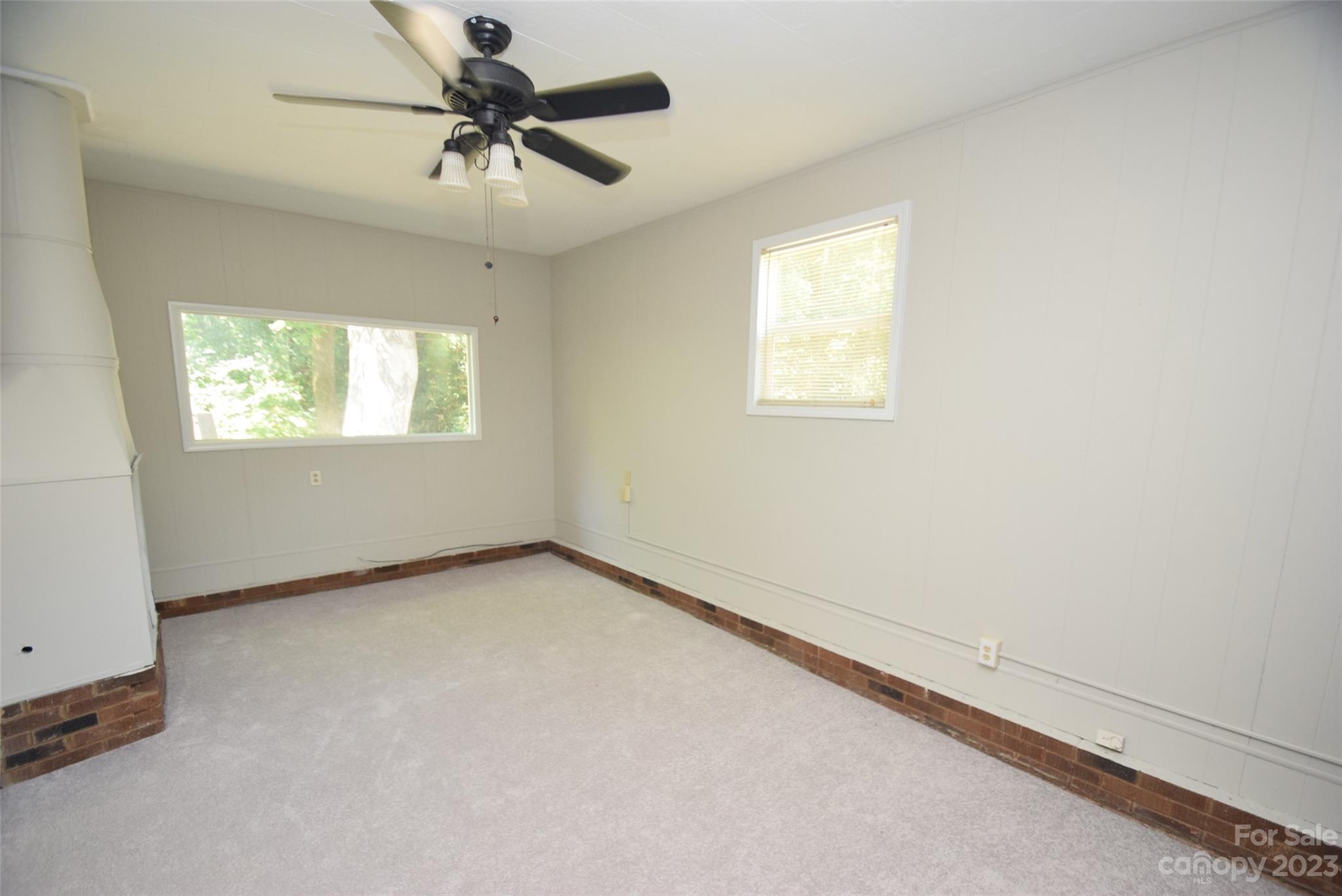 8429 Fieldwood Road Mint Hill, NC 28227 - Photo 13 of 28 an empty room with windows and fan