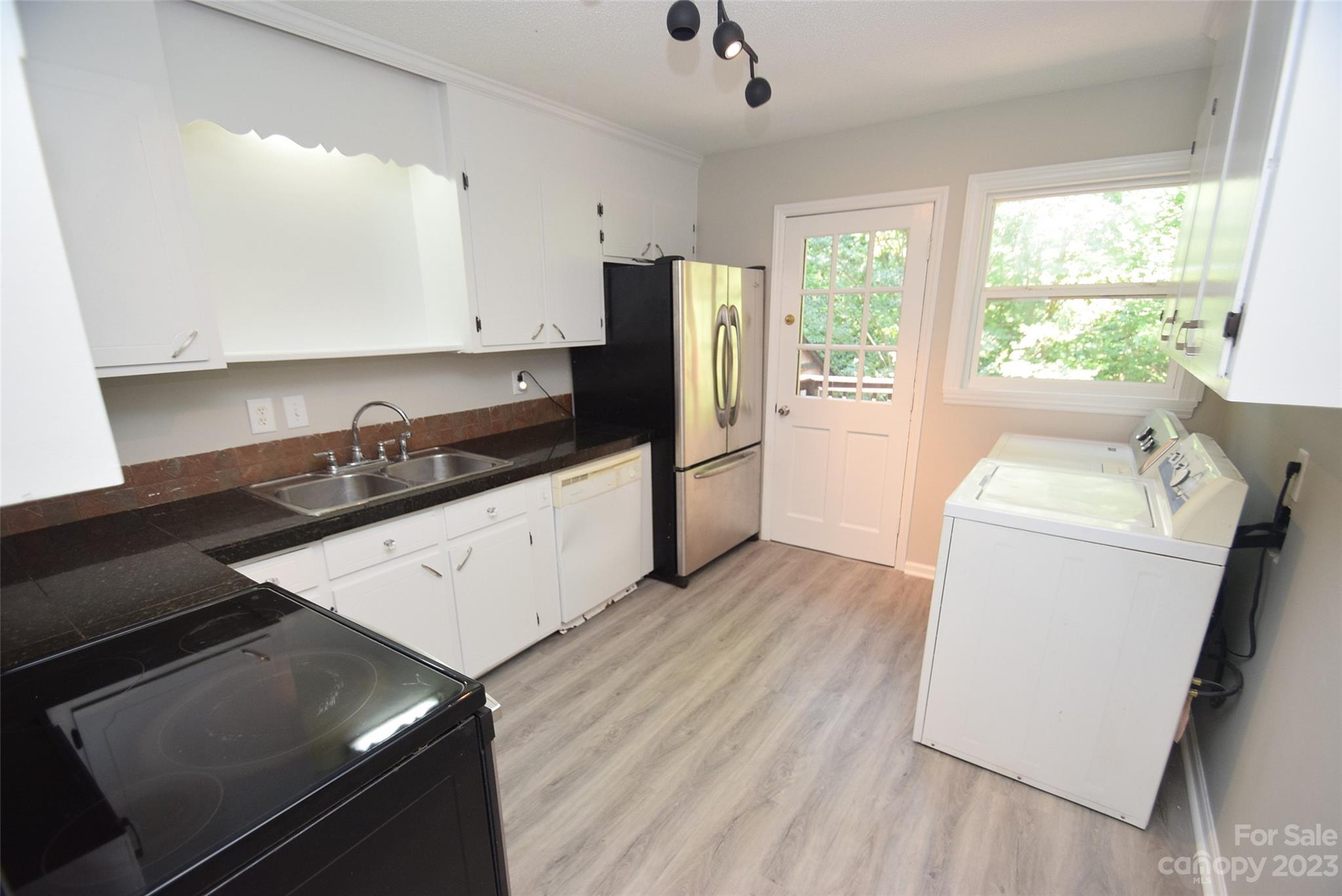 8429 Fieldwood Road Mint Hill, NC 28227 - Photo 15 of 28 a kitchen with a sink a stove and cabinets