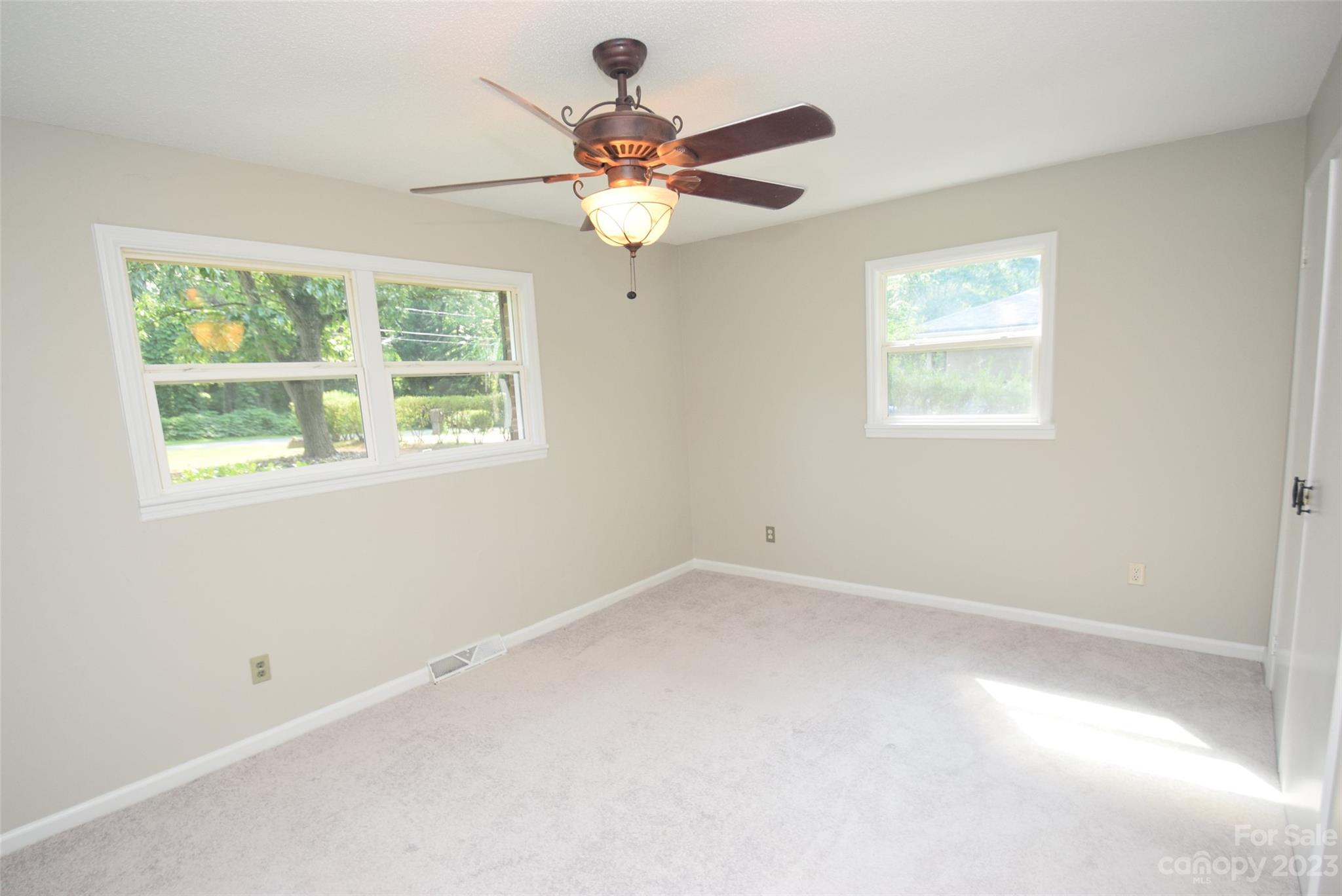 8429 Fieldwood Road Mint Hill, NC 28227 - Photo 20 of 28 an empty room with a window and a fan