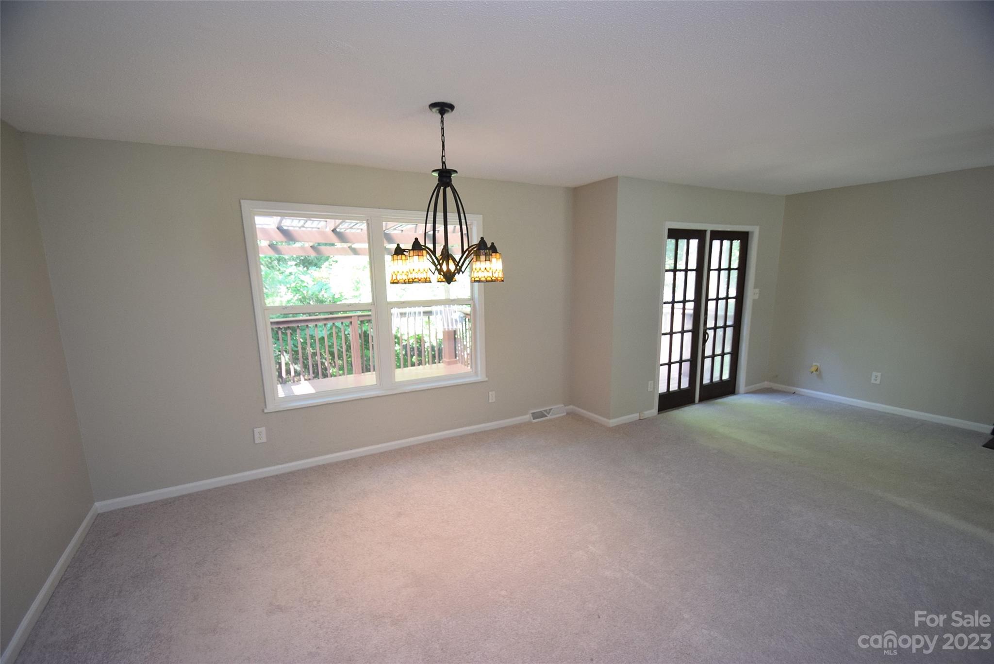 8429 Fieldwood Road Mint Hill, NC 28227 - Photo 10 of 28 a view of empty room with windows and chandelier fan
