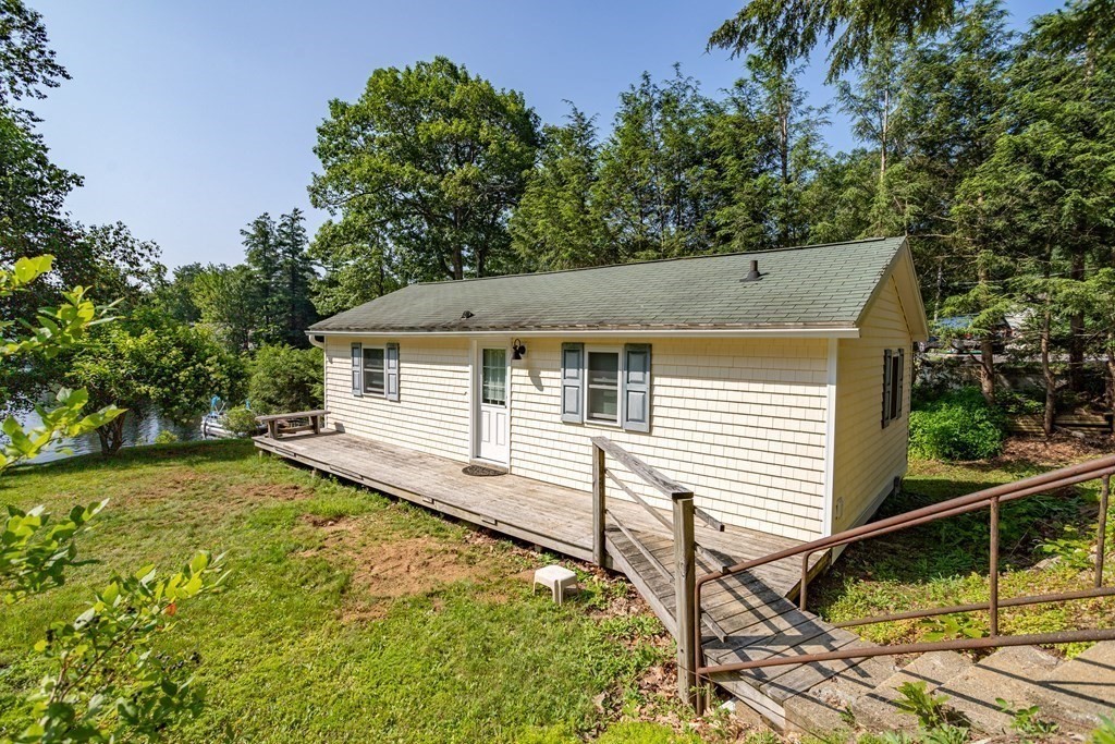 27 Hay Road Ashburnham, MA 01430 - Photo 1 of 42 a view of a white house with a small yard and large tree