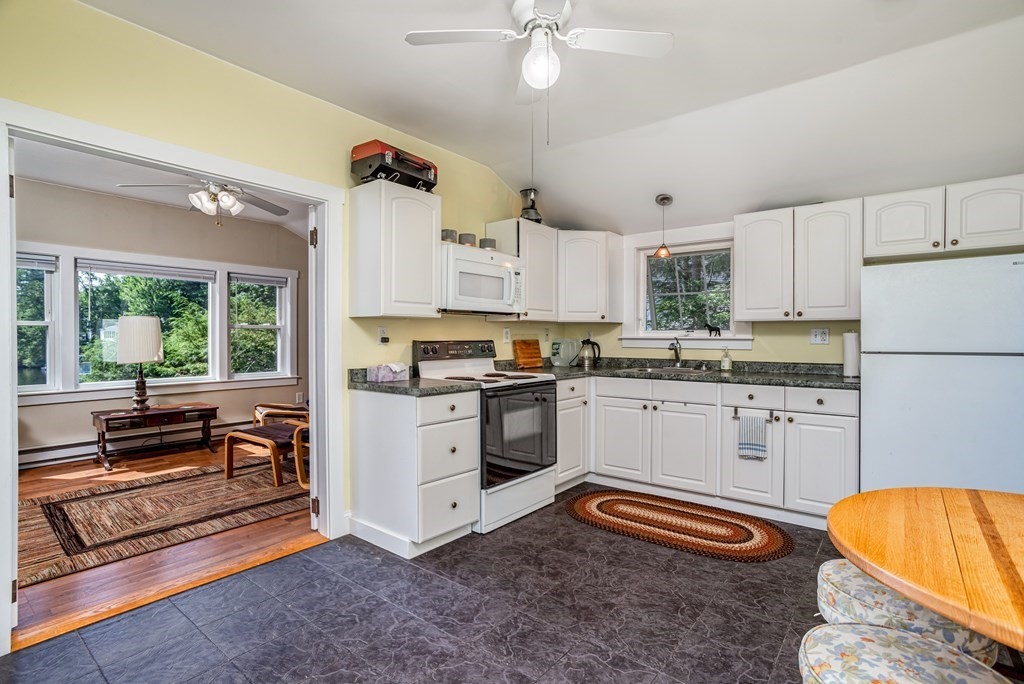 27 Hay Road Ashburnham, MA 01430 - Photo 22 of 42 a kitchen with stainless steel appliances a stove a refrigerator and white cabinets