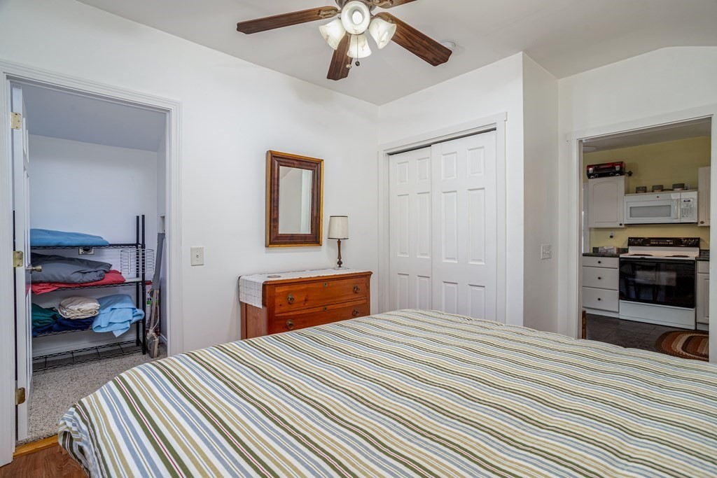 27 Hay Road Ashburnham, MA 01430 - Photo 28 of 42 a bedroom with a bed and a chandelier