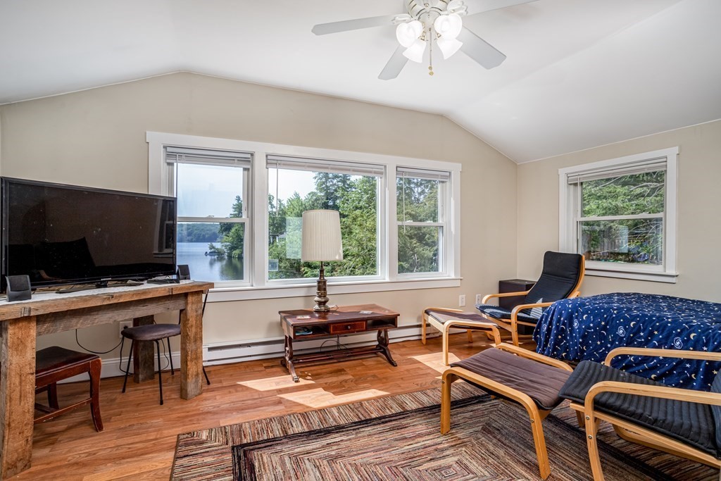 27 Hay Road Ashburnham, MA 01430 - Photo 29 of 42 a living room with furniture a flat screen tv and a large window