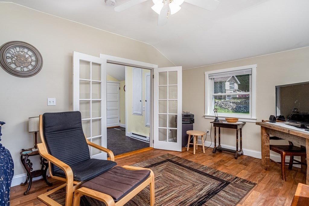 27 Hay Road Ashburnham, MA 01430 - Photo 31 of 42 a living room with furniture a flat screen tv and a window