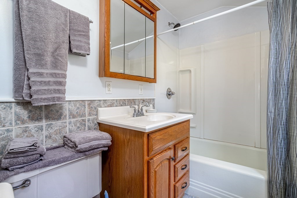 27 Hay Road Ashburnham, MA 01430 - Photo 34 of 42 a bathroom with a granite countertop sink a mirror and a bathtub
