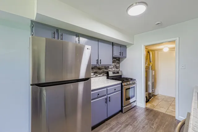 a kitchen with a refrigerator a stove top oven a sink and dishwasher