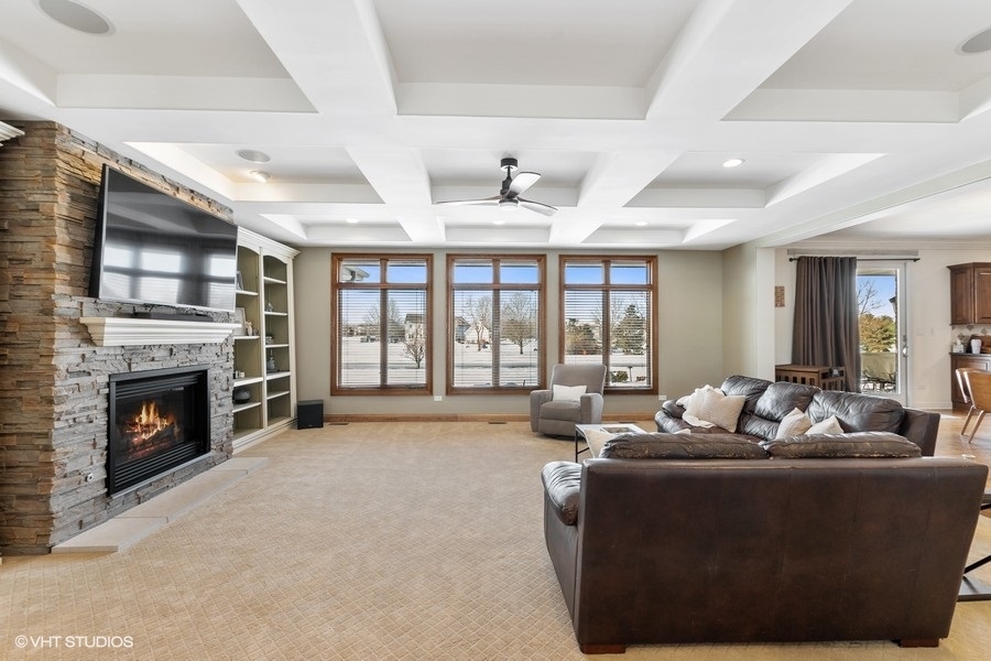 24042 Old Farm Road Manhattan, IL 60442 - Photo 12 of 32 a living room with furniture a fireplace and a large window