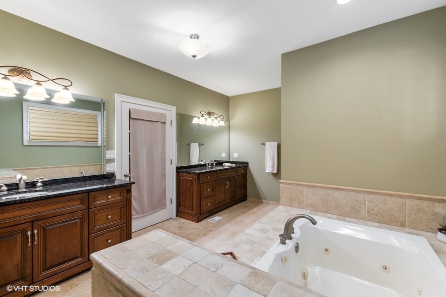 24042 Old Farm Road Manhattan, IL 60442 - Photo 17 of 32 a spacious bathroom with a tub sink and mirror