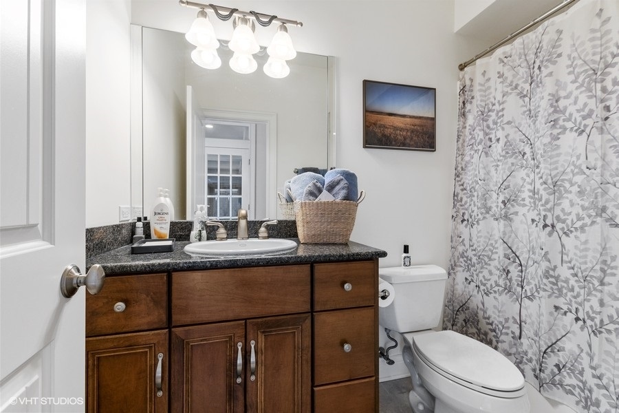 24042 Old Farm Road Manhattan, IL 60442 - Photo 20 of 32 a bathroom with a granite countertop toilet sink and mirror