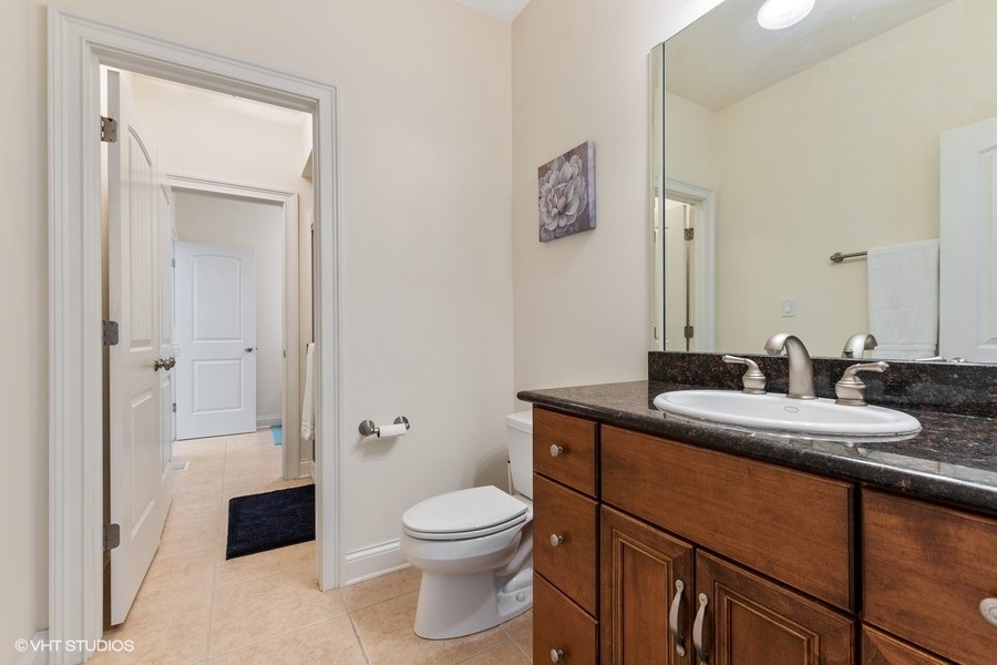 24042 Old Farm Road Manhattan, IL 60442 - Photo 22 of 32 a bathroom with a granite countertop sink a toilet and shower