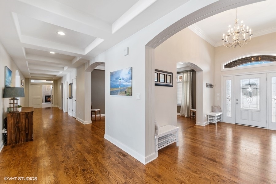 24042 Old Farm Road Manhattan, IL 60442 - Photo 3 of 32 a view of a hallway with wooden floor and a living room
