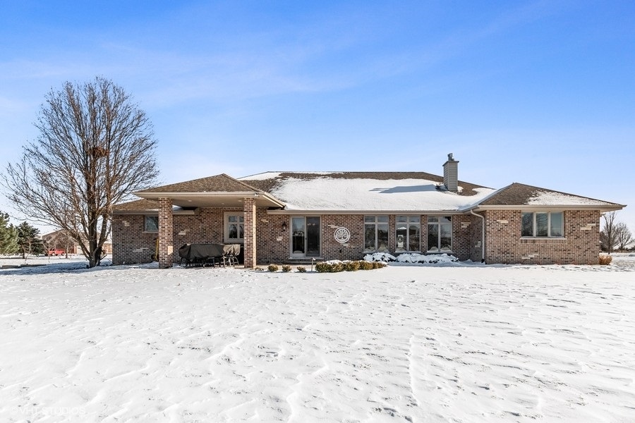 24042 Old Farm Road Manhattan, IL 60442 - Photo 31 of 32 a front view of a house with a yard covered in snow