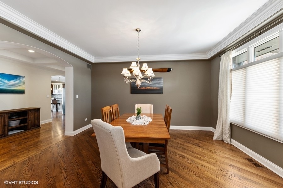 24042 Old Farm Road Manhattan, IL 60442 - Photo 5 of 32 a dining room with furniture a chandelier and wooden floor
