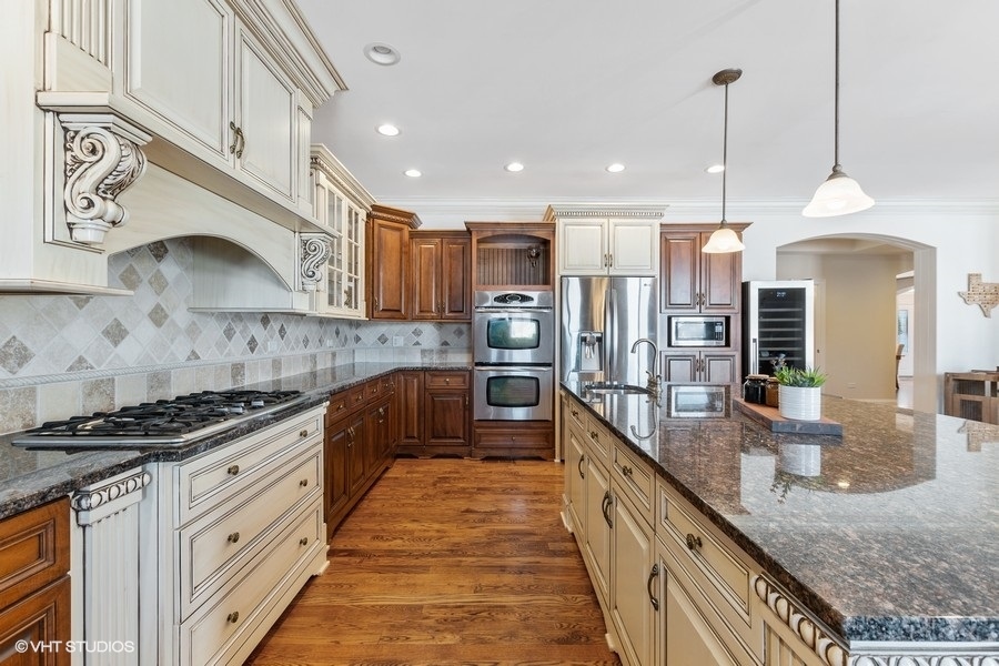 24042 Old Farm Road Manhattan, IL 60442 - Photo 9 of 32 a kitchen with stainless steel appliances granite countertop a stove a sink and a granite counter tops