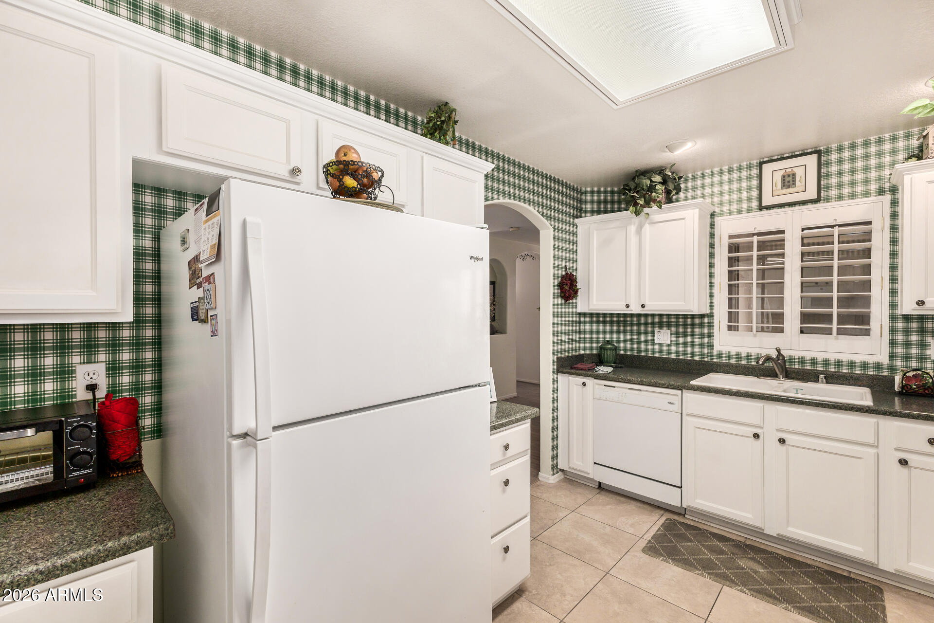8508 West Utopia Road Peoria, AZ 85382 - Photo 12 of 28 a kitchen with stainless steel appliances granite countertop a refrigerator and a sink