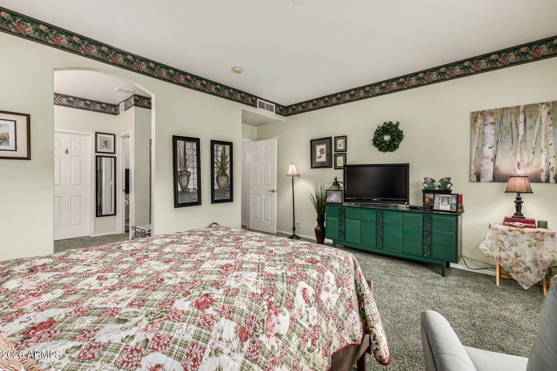 8508 West Utopia Road Peoria, AZ 85382 - Photo 17 of 28 a bedroom with a bed and a flat screen tv