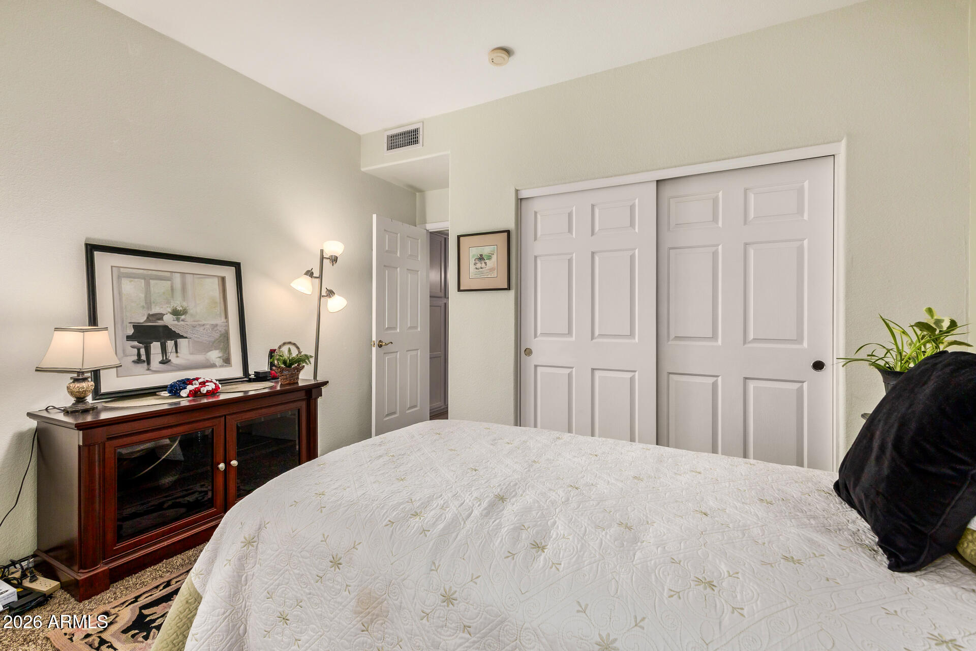 8508 West Utopia Road Peoria, AZ 85382 - Photo 22 of 28 a bedroom with a bed and a chandelier