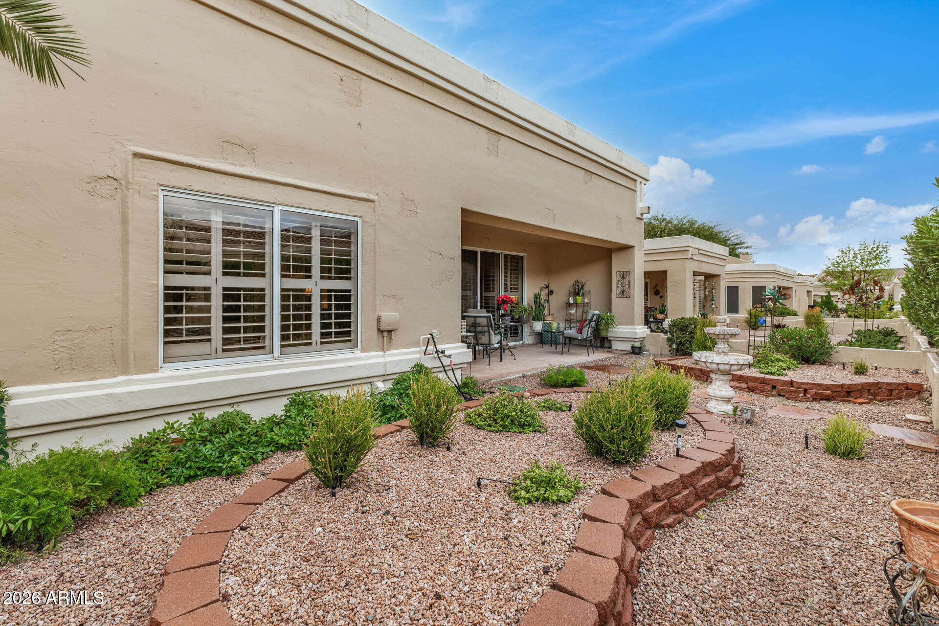 8508 West Utopia Road Peoria, AZ 85382 - Photo 28 of 28 a front view of a house with garden and outdoor seating
