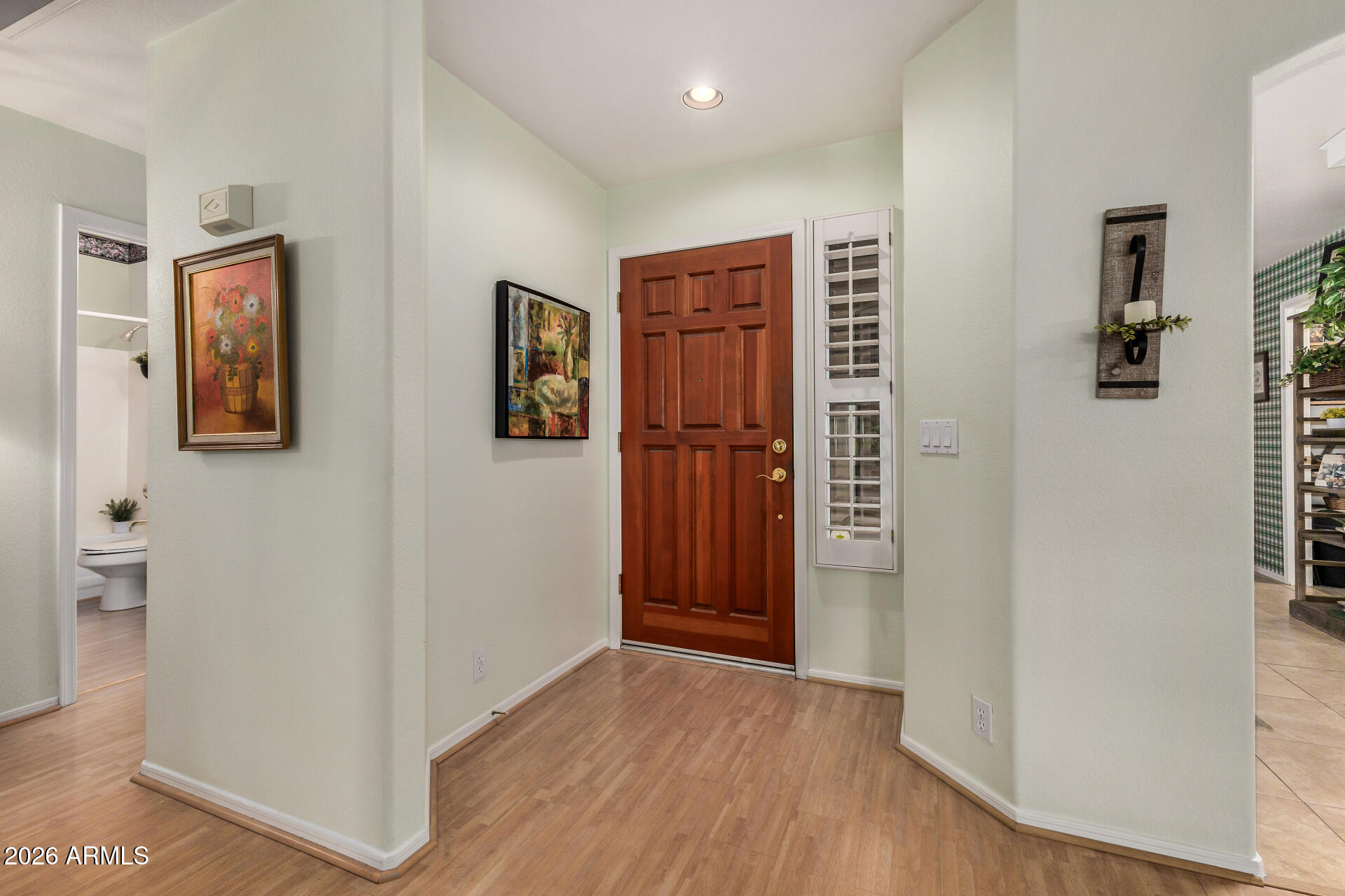 8508 West Utopia Road Peoria, AZ 85382 - Photo 4 of 28 a view of hallway with wooden floor and cabinet