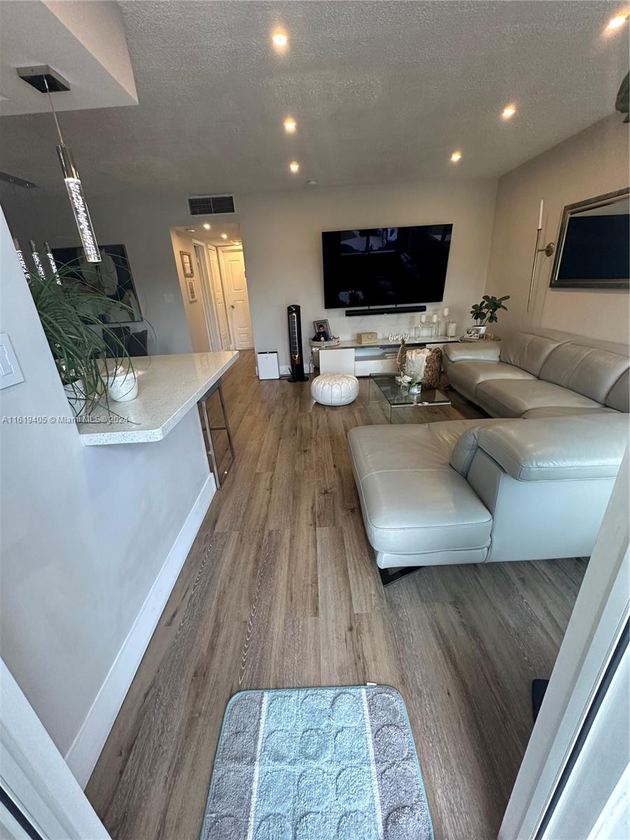 6791 Pershing Street Hollywood, FL 33024 - Photo 12 of 31 a living room with furniture and a flat screen tv