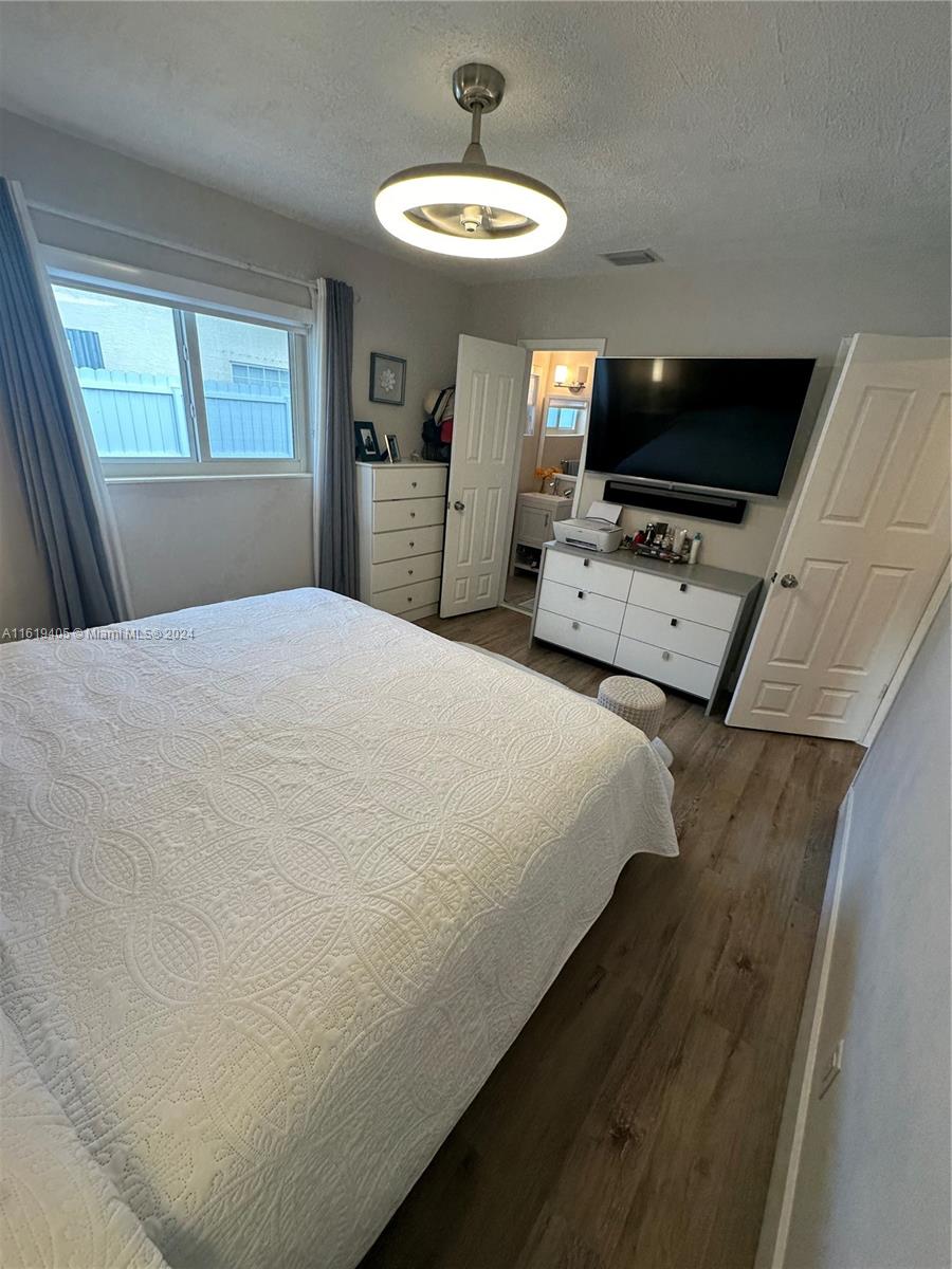 6791 Pershing Street Hollywood, FL 33024 - Photo 17 of 31 a bedroom with a bed and a flat screen tv