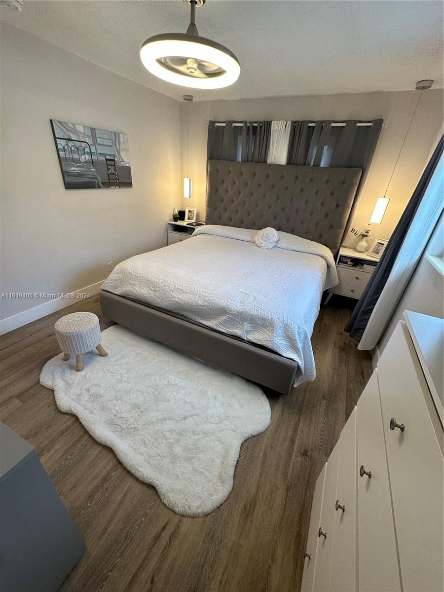 6791 Pershing Street Hollywood, FL 33024 - Photo 18 of 31 a bedroom with a bed and a night stand