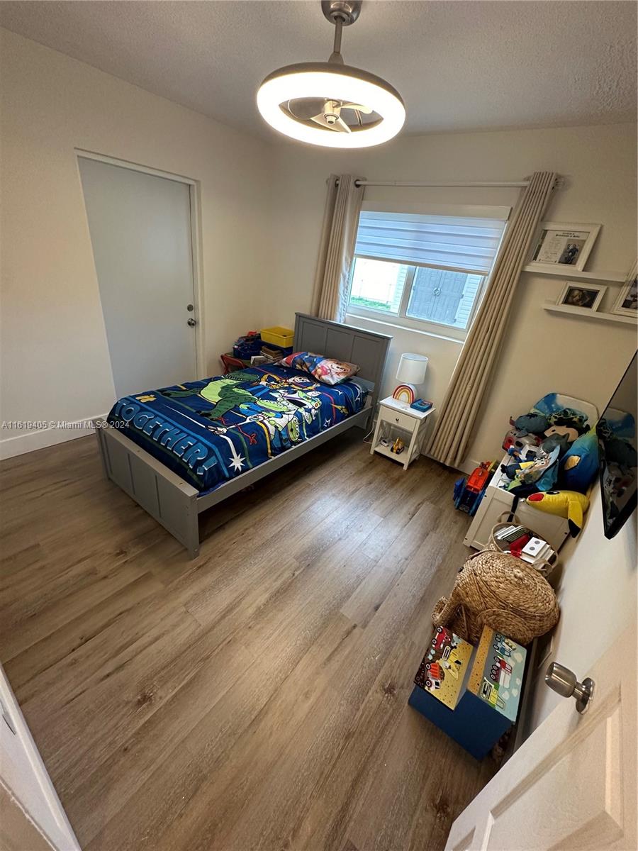 6791 Pershing Street Hollywood, FL 33024 - Photo 21 of 31 a living room with furniture and a wooden floor