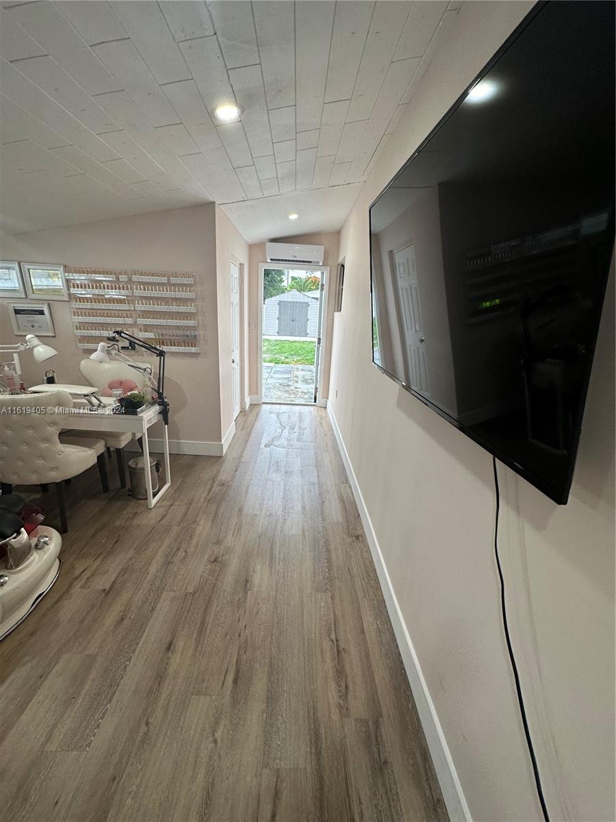 6791 Pershing Street Hollywood, FL 33024 - Photo 23 of 31 a living room with furniture and a wooden floor