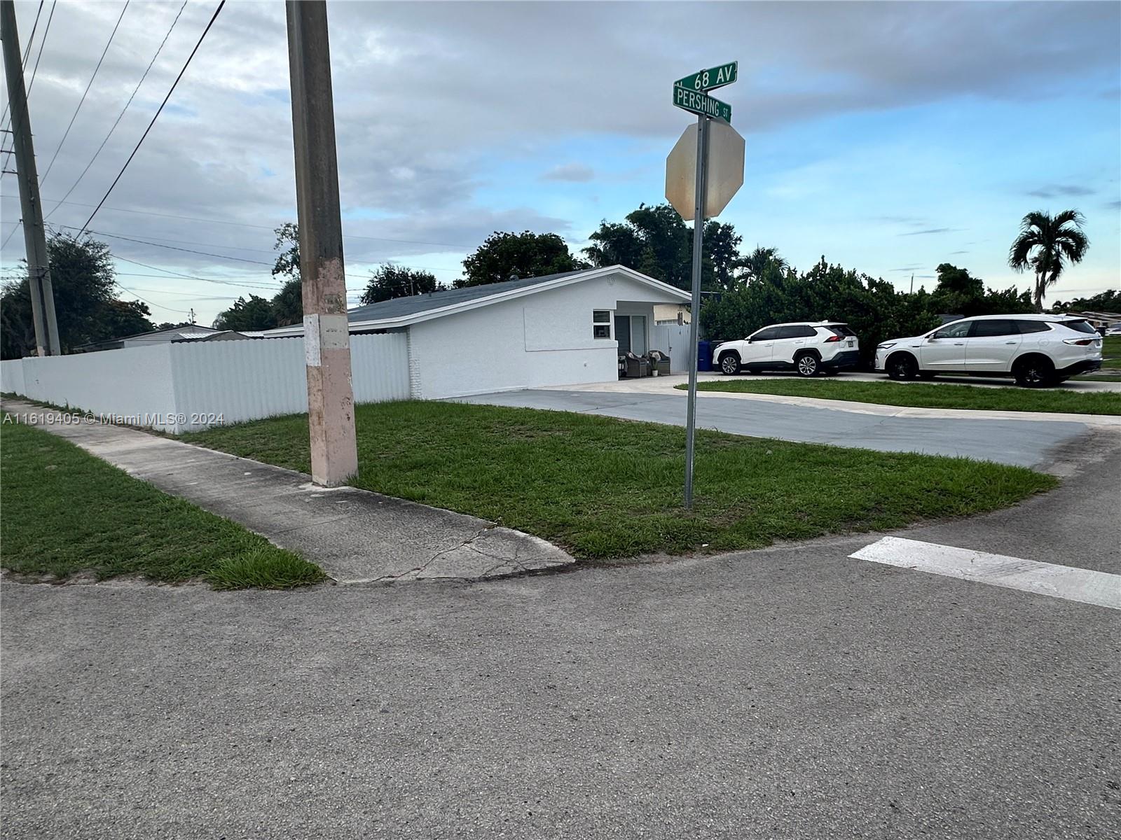 6791 Pershing Street Hollywood, FL 33024 - Photo 27 of 31 a front view of a house with a yard and garage