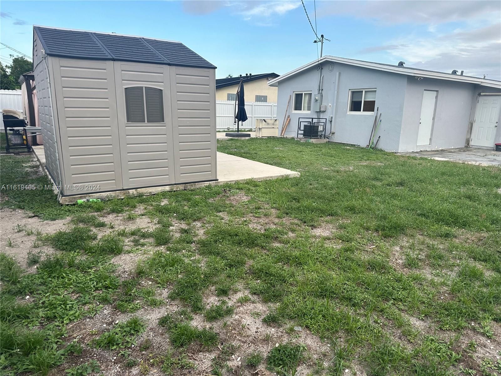 6791 Pershing Street Hollywood, FL 33024 - Photo 30 of 31 a view of a yard in front of a house