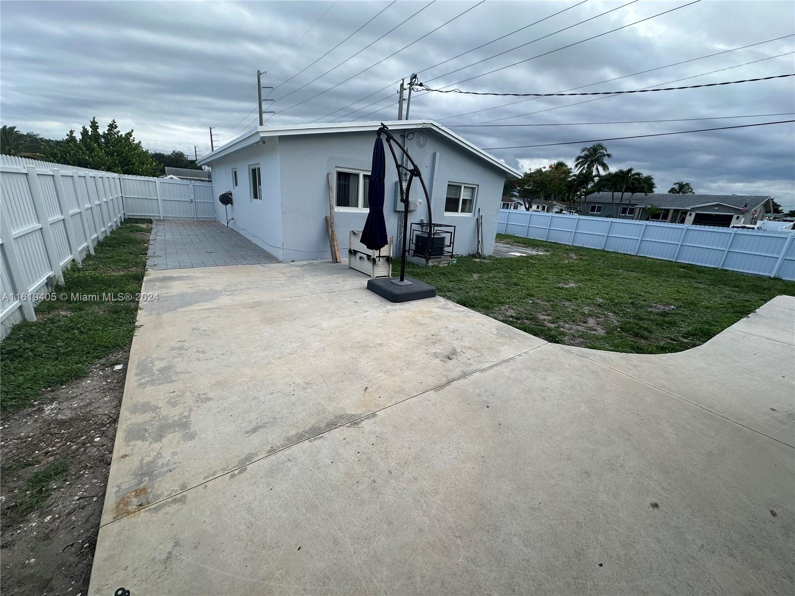 6791 Pershing Street Hollywood, FL 33024 - Photo 31 of 31 a view of a house with a yard potted plants