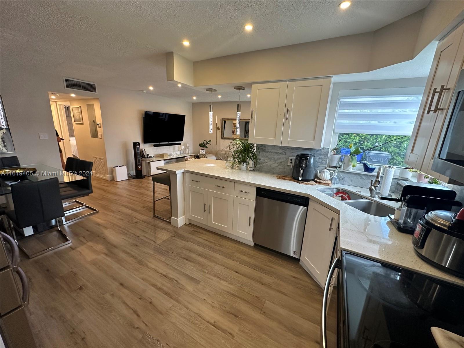 6791 Pershing Street Hollywood, FL 33024 - Photo 4 of 31 a kitchen with a sink appliances and cabinets