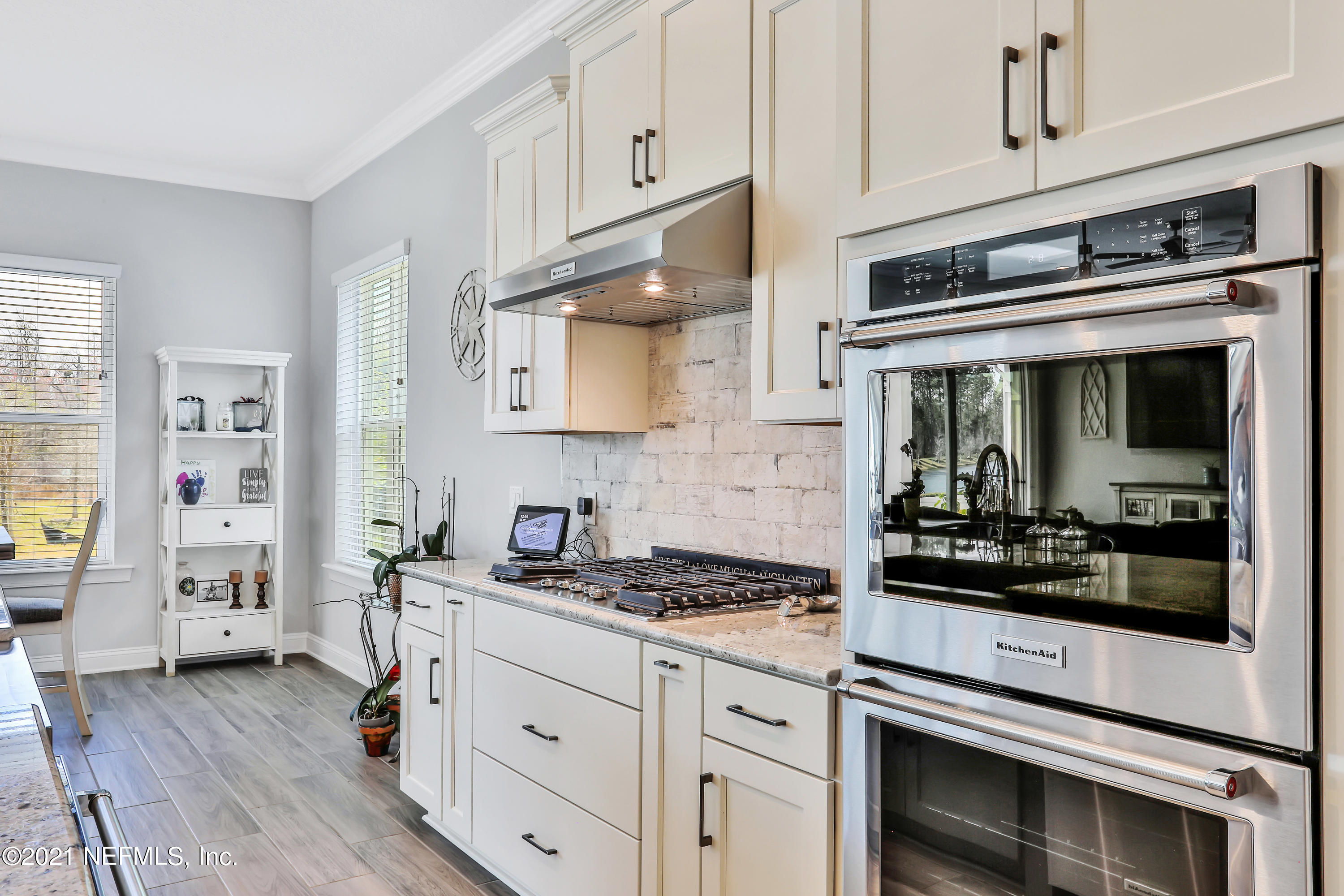 140 Pine Haven Drive St. Johns, FL 32259 - Photo 11 of 66 a kitchen with granite countertop cabinets stainless steel appliances and wooden floor