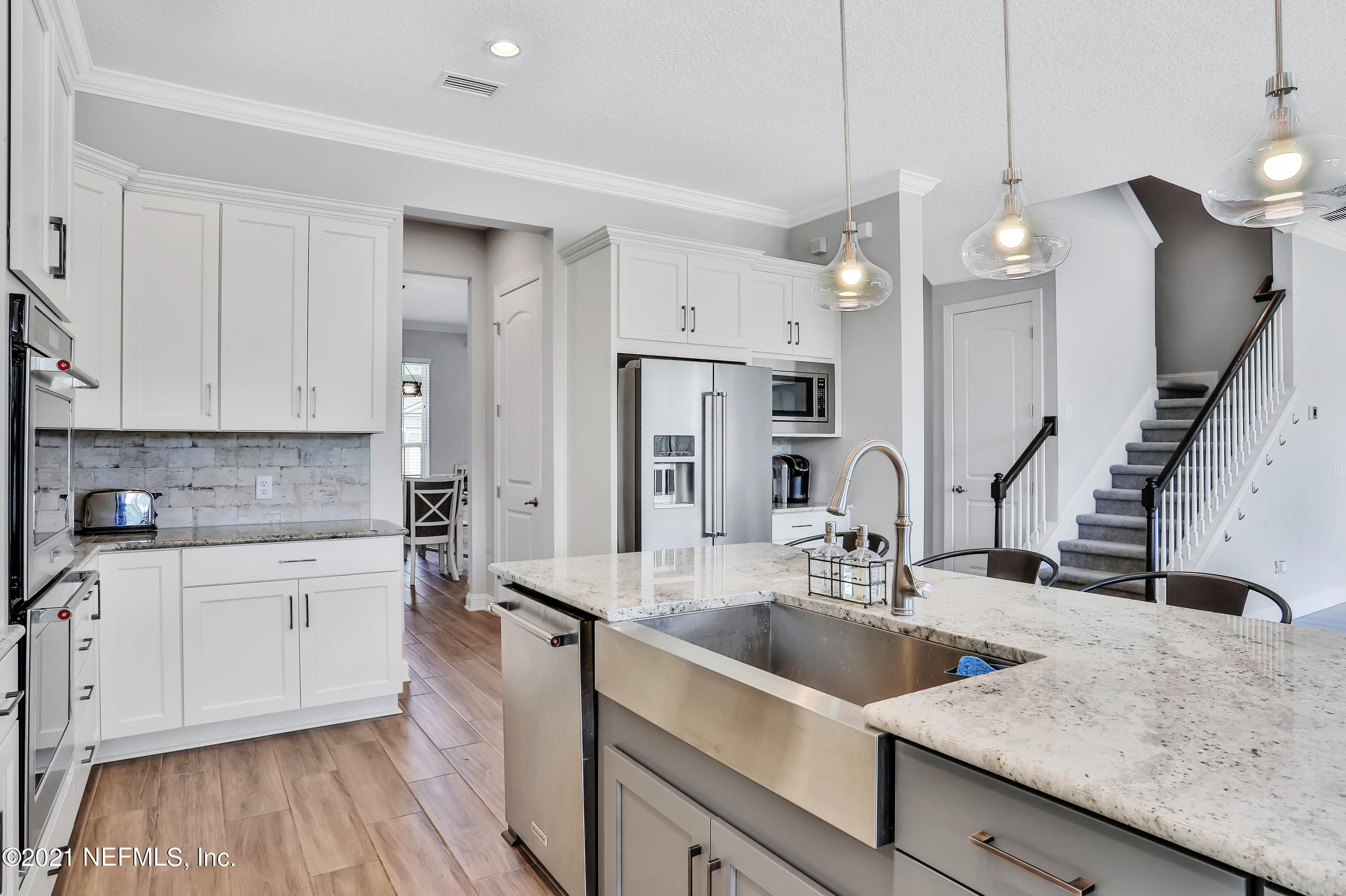 140 Pine Haven Drive St. Johns, FL 32259 - Photo 12 of 66 a kitchen with granite countertop a sink a counter space appliances and cabinets