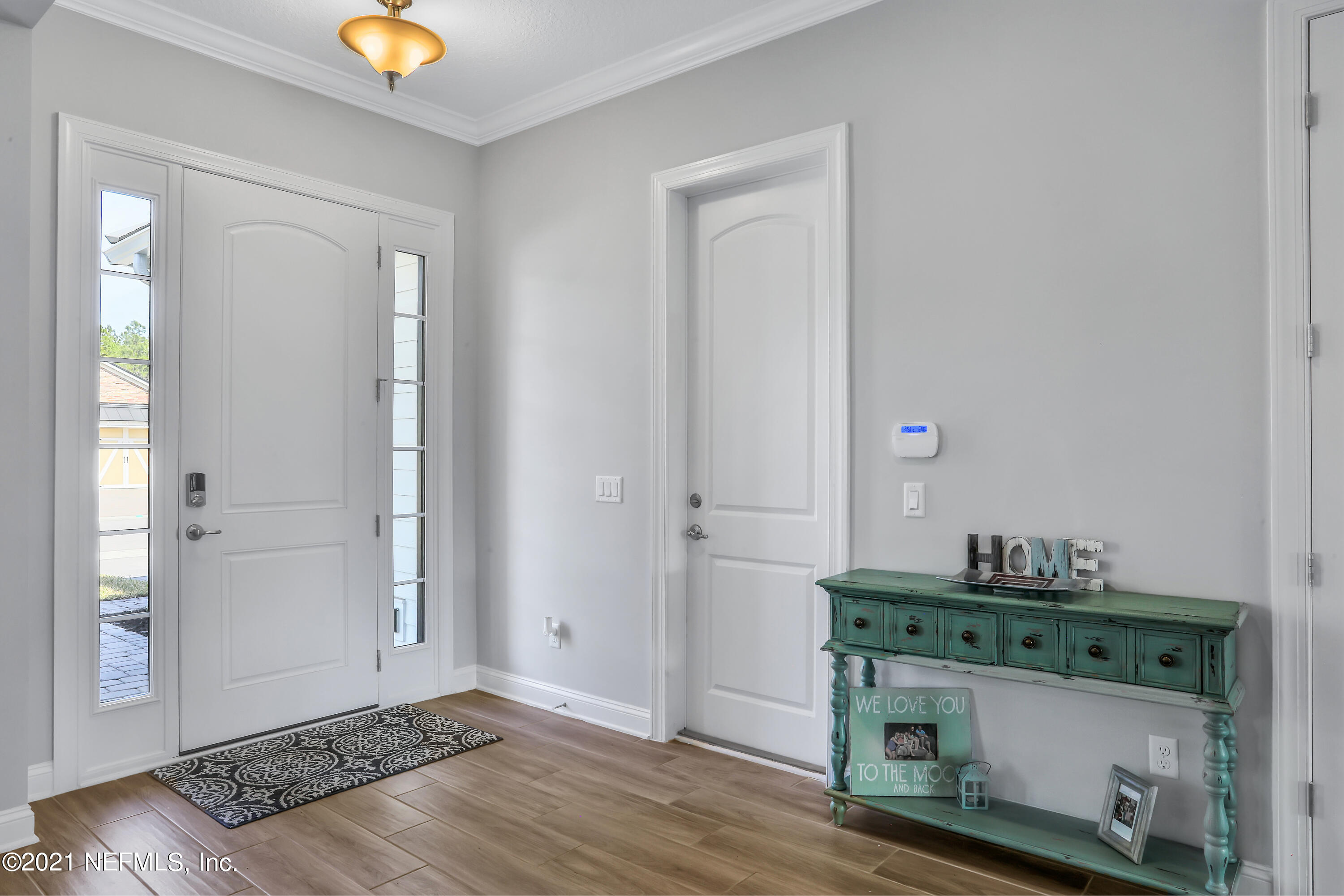 140 Pine Haven Drive St. Johns, FL 32259 - Photo 3 of 66 an empty room with wooden floor and cabinet