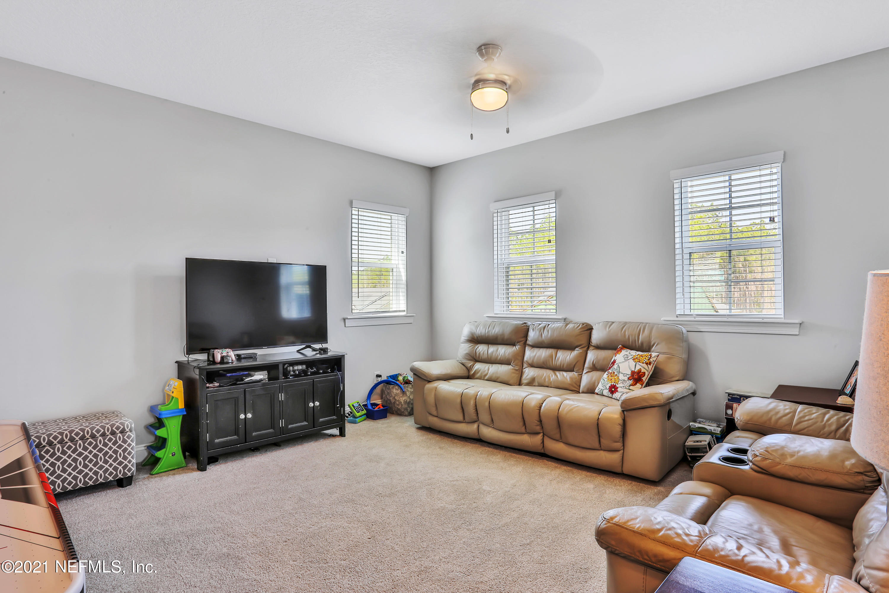 140 Pine Haven Drive St. Johns, FL 32259 - Photo 32 of 66 a living room with furniture and a flat screen tv