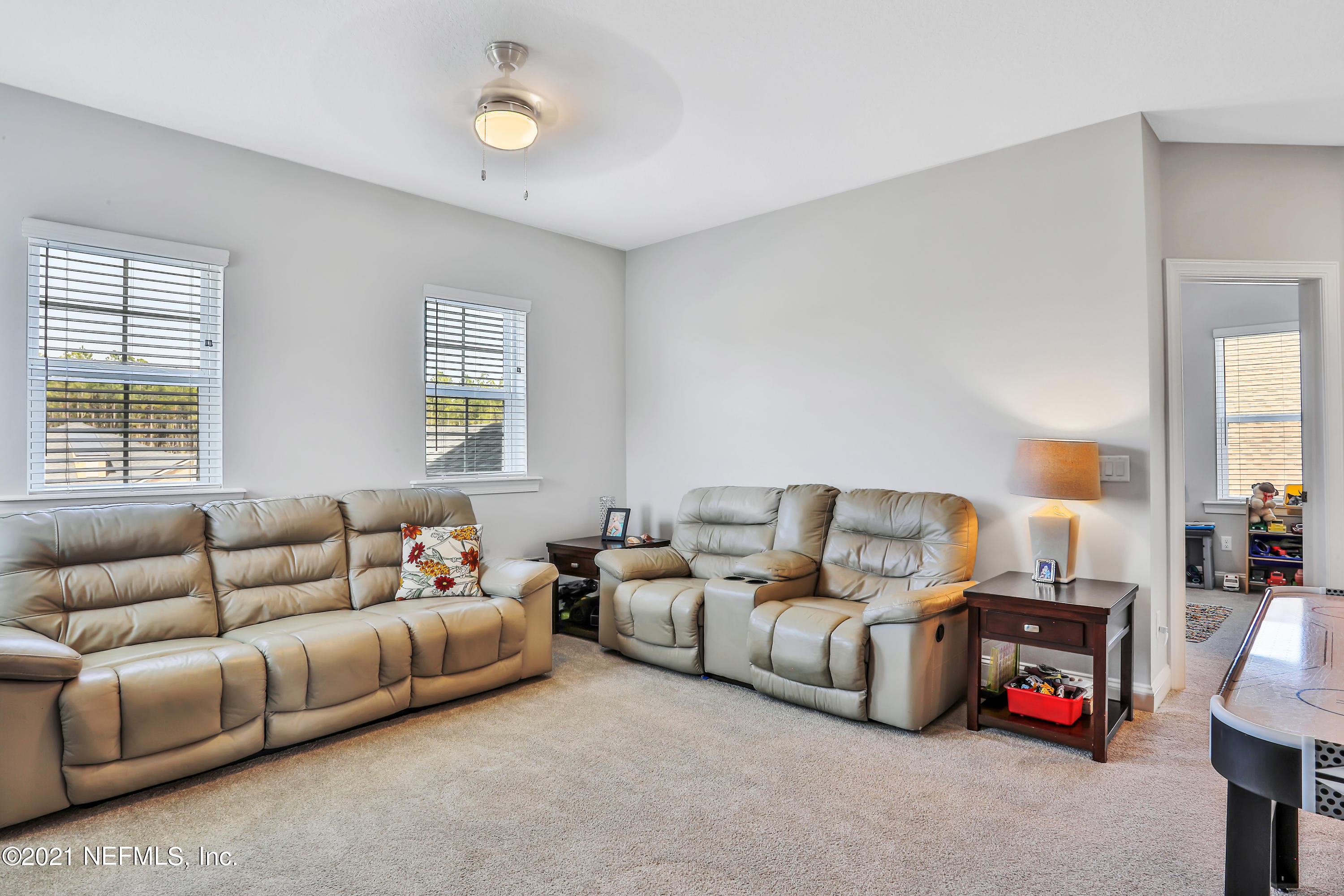 140 Pine Haven Drive St. Johns, FL 32259 - Photo 39 of 66 a living room with furniture a fireplace and a large window