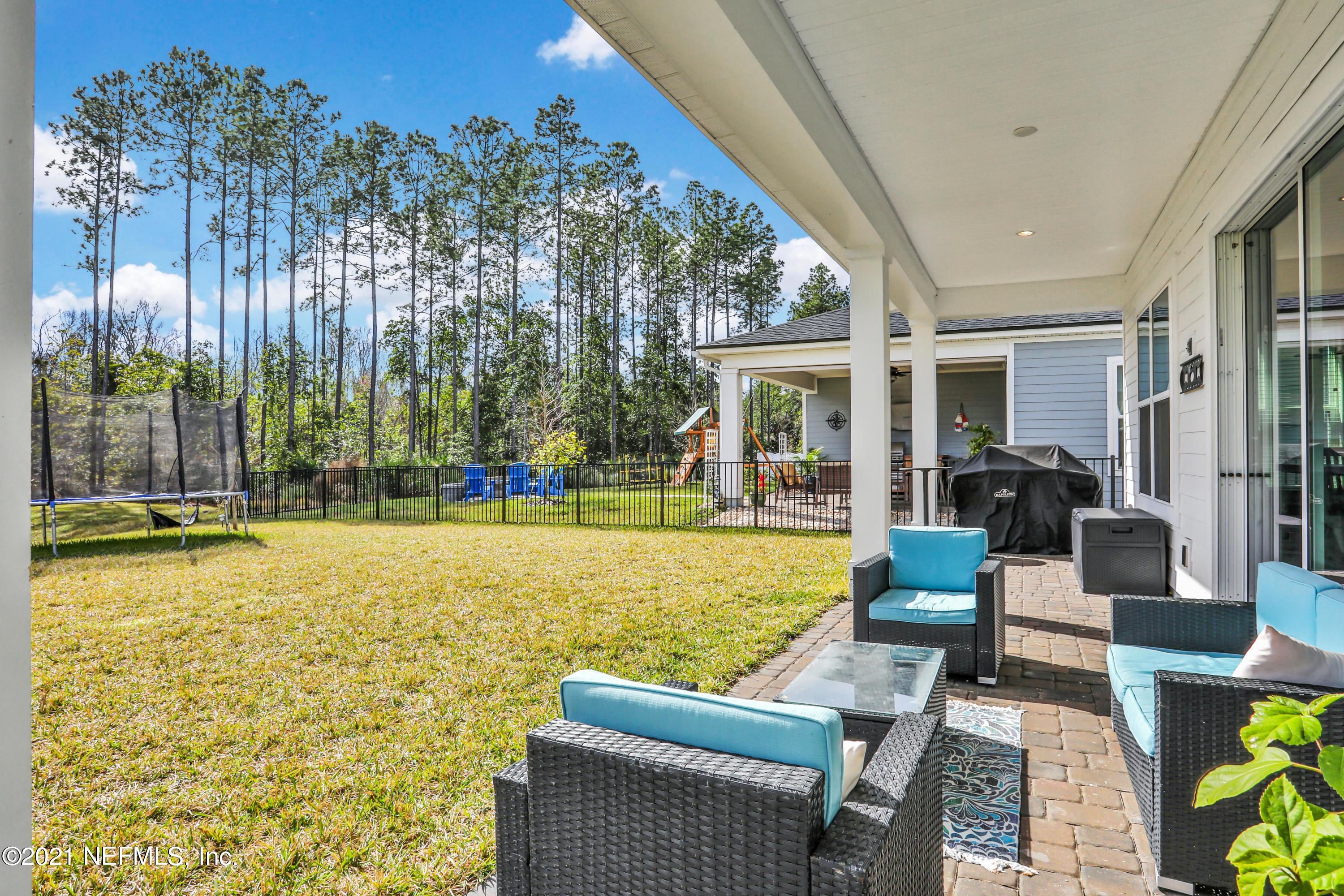 140 Pine Haven Drive St. Johns, FL 32259 - Photo 50 of 66 a view of swimming pool with seating space and trees in the background