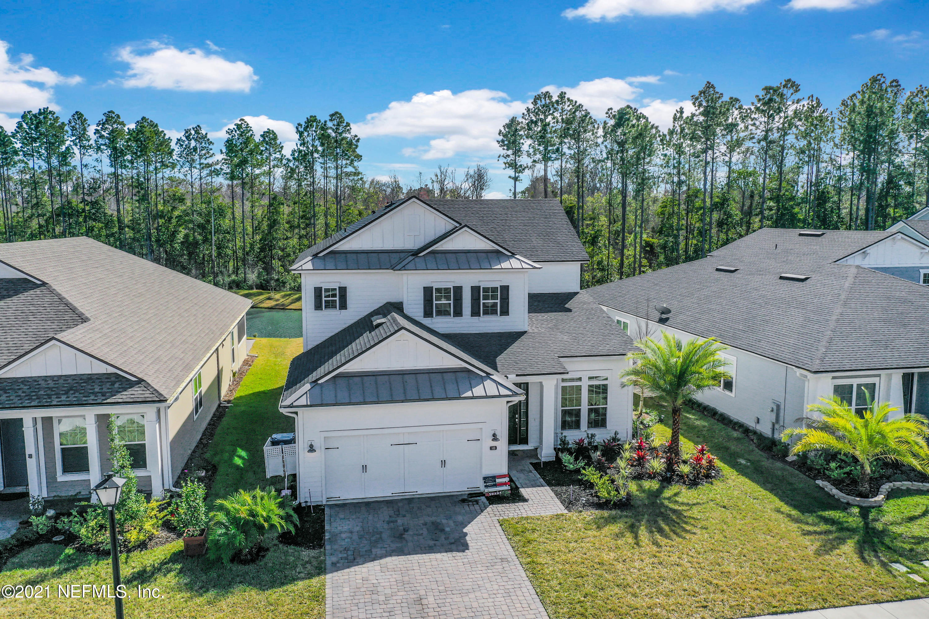 140 Pine Haven Drive St. Johns, FL 32259 - Photo 62 of 66 a aerial view of a house with a yard table and chairs