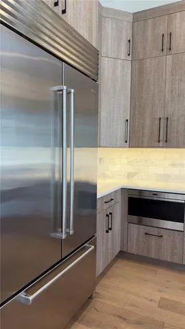 a bathroom with a granite countertop sink a toilet and a mirror