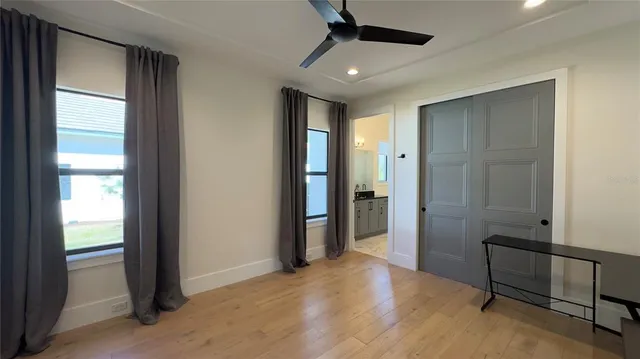 an empty room with windows and closet