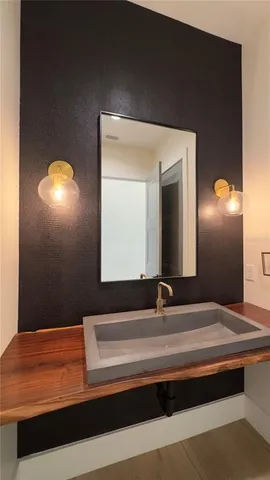 a bathroom with a double vanity sink and a mirror