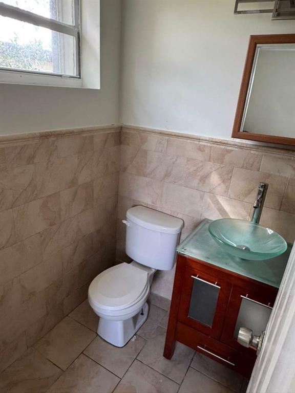 1042 Foster Road Hallandale Beach, FL 33009 - Photo 5 of 8 a bathroom with a toilet and a sink