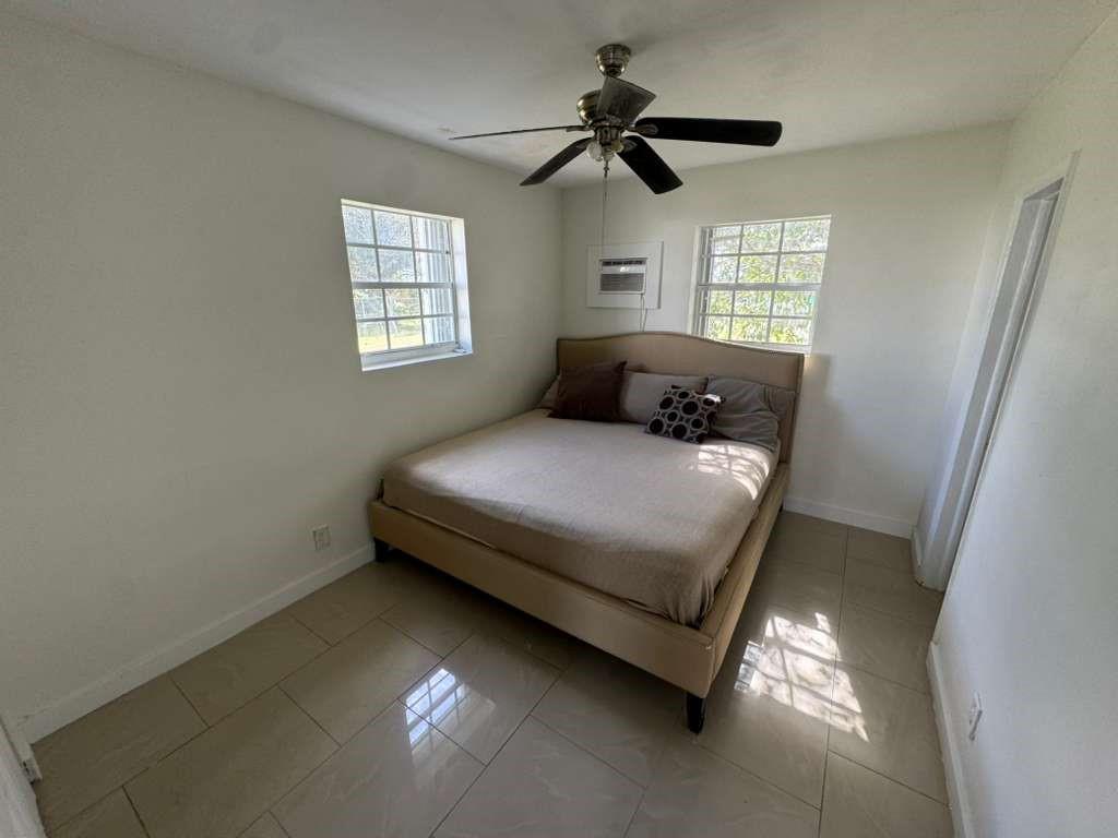 1042 Foster Road Hallandale Beach, FL 33009 - Photo 8 of 8 a bedroom with a bed and a window
