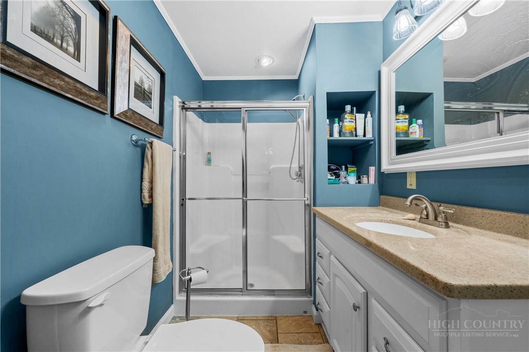 467 Horseshoe Ridge Road East Deep Gap, NC 28618 - Photo 27 of 46 a bathroom with a sink toilet and shower